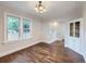Sunlit dining room with hardwood floors features stylish lighting and built-in cabinet at 1351 Brentwood St, Lakewood, CO 80214