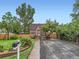 Inviting brick home with a well-manicured front yard, lovely flowers, and mature tree at 1351 Brentwood St, Lakewood, CO 80214
