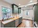 Bright kitchen with stainless steel appliances, hardwood floors, and gray cabinets at 1351 Brentwood St, Lakewood, CO 80214