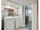 Convenient laundry room with modern washer and dryer units, and a full bathroom at 1351 Brentwood St, Lakewood, CO 80214