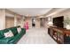 Finished basement featuring a green couch, a TV, and access to other parts of the home at 5271 N Mesa Dr, Castle Rock, CO 80108