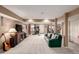 Open finished basement features a green couch, a TV, an elliptical, and access to the backyard at 5271 N Mesa Dr, Castle Rock, CO 80108