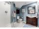 This bathroom features blue walls, a single sink vanity, a walk-in shower, and tile floors at 5271 N Mesa Dr, Castle Rock, CO 80108