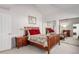 This bedroom features a wooden frame bed, closet with mirrored sliding doors, and a neutral carpet at 5271 N Mesa Dr, Castle Rock, CO 80108
