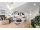 Bright living room with hardwood floors, a fireplace, a staircase, and an oversized sectional sofa at 5271 N Mesa Dr, Castle Rock, CO 80108