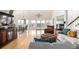 Bright living room with hardwood floors, a fireplace, a staircase, and an oversized sectional sofa at 5271 N Mesa Dr, Castle Rock, CO 80108