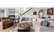 Bright living room with hardwood floors, a fireplace, a staircase, and an oversized sectional sofa at 5271 N Mesa Dr, Castle Rock, CO 80108