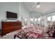 Bright bedroom features a sleek television, a fireplace and access to the private balcony at 5271 N Mesa Dr, Castle Rock, CO 80108