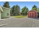 Landscaped backyard with a red outbuilding, and well-manicured lawn at 1183 S Pierson Ct, Denver, CO 80232