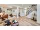 Finished basement with cozy seating area, stairs, light flooring, and plenty of natural light at 1183 S Pierson Ct, Denver, CO 80232