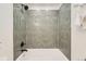 Bathroom boasting white tub, sleek green tile surround, and black matte fixtures at 1183 S Pierson Ct, Denver, CO 80232