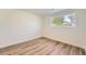 Clean and bright bedroom with wood floors and a large window overlooking the outdoors at 1183 S Pierson Ct, Denver, CO 80232