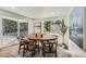 Bright dining room with a wooden table, six chairs, large windows and sliding glass doors at 1183 S Pierson Ct, Denver, CO 80232