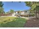 Rear exterior view of home with deck and landscaping at 1183 S Pierson Ct, Denver, CO 80232