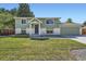Charming two-story home with a well-manicured lawn, lush landscaping, and attached two car garage at 1183 S Pierson Ct, Denver, CO 80232