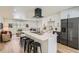 Open floor plan features a modern kitchen with a large island and a living area with a comfortable couch at 1183 S Pierson Ct, Denver, CO 80232