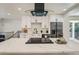A modern kitchen with white cabinets, a large island with bar seating, and stainless steel appliances at 1183 S Pierson Ct, Denver, CO 80232