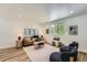Inviting living room featuring modern furnishings, wood floors, and natural lighting at 1183 S Pierson Ct, Denver, CO 80232