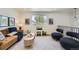 Bright living room with cozy seating, stylish decor, and a large window offering natural light at 1183 S Pierson Ct, Denver, CO 80232