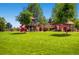 Wide view of the well-equipped playground set in a large grassy field at 1183 S Pierson Ct, Denver, CO 80232
