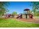 Community playground featuring multiple slides, climbing structures, and ample green space at 1183 S Pierson Ct, Denver, CO 80232