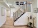 Bright staircase featuring modern wood railing and metal balusters leads to upper level at 1183 S Pierson Ct, Denver, CO 80232