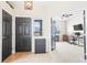 Inviting foyer featuring tile flooring, modern lighting, and an open view into the living spaces at 209 Falmouth St, Castle Rock, CO 80104