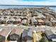 Aerial view features a neighborhood near a large lake with residences lining the streets and mature trees throughout the community at 4935 S Zephyr St, Littleton, CO 80123