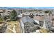 An aerial view of a two-story house shows its manicured lawn and a pathway to a wooden bench at 4935 S Zephyr St, Littleton, CO 80123