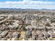 A high aerial view displays an idyllic neighborhood with mature trees and houses spread out, backed by distant mountains at 4935 S Zephyr St, Littleton, CO 80123