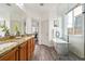Bright bathroom featuring a soaking tub, shower, and dual vanities with granite countertops, blending functionality and elegance at 4935 S Zephyr St, Littleton, CO 80123