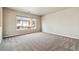 Cozy bedroom with a large window, neutral carpet, and great natural light at 4935 S Zephyr St, Littleton, CO 80123