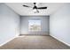 Clean bedroom with a ceiling fan, large window, and neutral carpet at 4935 S Zephyr St, Littleton, CO 80123