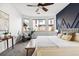 Inviting bedroom with a bay window, unique accent wall, and comfortable seating area, ideal for relaxation at 4935 S Zephyr St, Littleton, CO 80123