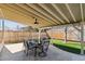 A covered patio with an outdoor dining set, perfect for enjoying outdoor meals at 4935 S Zephyr St, Littleton, CO 80123