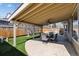 Backyard with covered patio and outdoor dining set, featuring a fan for added comfort at 4935 S Zephyr St, Littleton, CO 80123
