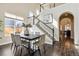 Dining area featuring modern lighting, an adjacent staircase, and an archway entrance at 4935 S Zephyr St, Littleton, CO 80123