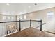 Upstairs hallway featuring neutral walls, a carpeted floor, and black-and-white railing at 4935 S Zephyr St, Littleton, CO 80123