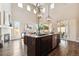 Open-concept kitchen with a large island, granite countertops, and modern lighting at 4935 S Zephyr St, Littleton, CO 80123