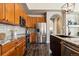 Kitchen features stainless steel appliances, granite countertops, wooden cabinets, and modern lighting at 4935 S Zephyr St, Littleton, CO 80123