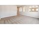 Carpeted living room with decorative archways and neutral paint at 4935 S Zephyr St, Littleton, CO 80123