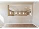 Open living room features an architectural cutout with carpeted floor and beige walls at 4935 S Zephyr St, Littleton, CO 80123