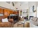 Open-concept living room featuring a modern kitchen, fireplace, and high ceilings, creating an inviting and spacious atmosphere at 4935 S Zephyr St, Littleton, CO 80123