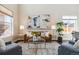 Stylish living room with modern decor, hardwood floors, and large windows at 4935 S Zephyr St, Littleton, CO 80123