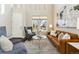 Bright living room featuring modern furniture, a large window, and high ceilings at 4935 S Zephyr St, Littleton, CO 80123