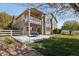 A backyard patio with outdoor furniture and a partially-covered balcony above at 10044 E 146Th Pl, Brighton, CO 80602