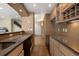 Basement bar area featuring granite counters, wood cabinets and tile floors at 10044 E 146Th Pl, Brighton, CO 80602