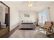 Bright bedroom with hardwood floors, a rocking chair, and a cozy rug, bathed in natural light at 10044 E 146Th Pl, Brighton, CO 80602