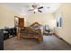 Bright bedroom features a wood frame bed, ceiling fan, and large window at 10044 E 146Th Pl, Brighton, CO 80602