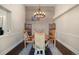 Cozy dining room is enhanced with an artistic light fixture and decorative wood wall design at 10044 E 146Th Pl, Brighton, CO 80602